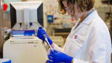 A scientist at Gilead Sciences analyzes patient antibody levels at the Gilead laboratory in Foster City, Calif.