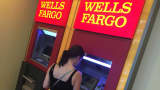 A woman uses a Wells Fargo ATM in New York City.