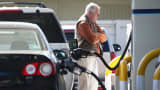A customer pumps gasoline into his car at an Arco gas station in Mill Valley, Calif.