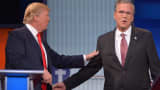 Real estate tycoon Donald Trump (L) and former Florida governor Jeb Bush (R) arrive on stage for the Republican presidential primary debate on August 6, 2015 at the Quicken Loans Arena in Cleveland, Ohio.