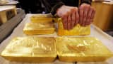 An Austrian worker handles ten kilogram 'raw' gold bars in Austrian gold bullion factory Oegussa in Vienna.