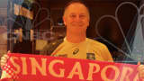 New Zealand Prime Minister John Key wears a Wallabies jersey, and a Singapore scarf, in honor of his bet with CNBC anchor Oriel Morrison.