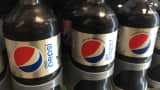Bottles of Diet Pepsi with, left, and without aspartame, center and right, sit in a case at a store in New York, August 8, 2015.