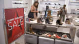 Shoppers look at shoes at a Macy's department store in New York.