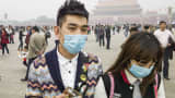 A couple wear face masks in Tiananmen Square in Beijing.
