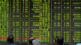 Investors observe the stock market at an exchange hall in Hangzhou, Zhejiang Province of China.