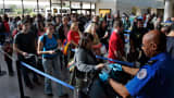 File photo: Travelers form a long security check line that is extended out of departure lounge at Los Angeles airport.