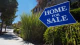 A 'Home For Sale' sign is displayed outside a house in Martinez, Calif.