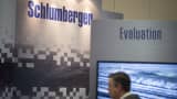 A man walks past the Schlumberger Ltd. booth at the DUG Eagle Ford Conference & Exhibition in San Antonio, Texas. (File Photo).