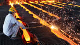 A worker cuts steel billets at an iron and steel enterprise in Ganyu County.