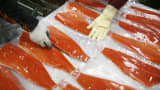 Workers stack sockeye salmon fillets after being vacuum packed to be frozen at the Alitak Cannery on Kodiak Island, Alaska. (File photo).