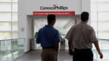 Employees arrive at ConocoPhillips headquarters in Houston, Texas.