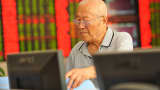 An investor checks stock information at a brokerage house in Fuyang, China.