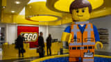 A Lego brick figurine of Emmet Brickowoski, a character from 'The Lego Movie', stands in the reception area at the headquarters of Lego A/S in Billund, Denmark.