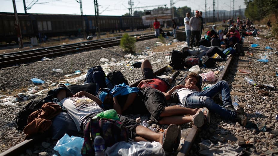 Syrian and Iraqi migrants sleep on railroad tracks waiting to be processed across the Macedonian border September 2, 2015 in Idomeni, Greece. Since the beginning of 2015 the number of migrants using the so-called 'Balkans route' has exploded with migrants arriving in Greece from Turkey and then travelling on through Macedonia and Serbia before entering the EU via Hungary. The number of people leaving their homes in war torn countries such as Syria, marks the largest migration of people since World War II.