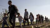 Hoping to cross into Hungary, migrants walk along a railway track outside the village of Horgos in Serbia, towards the border it shares with Hungary, September 2, 2015.