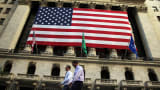 An American flag hangs over the New York Stock Exchange.