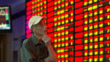An investor observes stock market at a stock exchagne hall on September 22, 2015 in Nanjing, China.