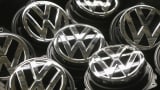 Volkswagen trunk ornaments bearing the VW logo lie next to the Golf VII assembly line at the Volkswagen factory in Wolfsburg, Germany.
