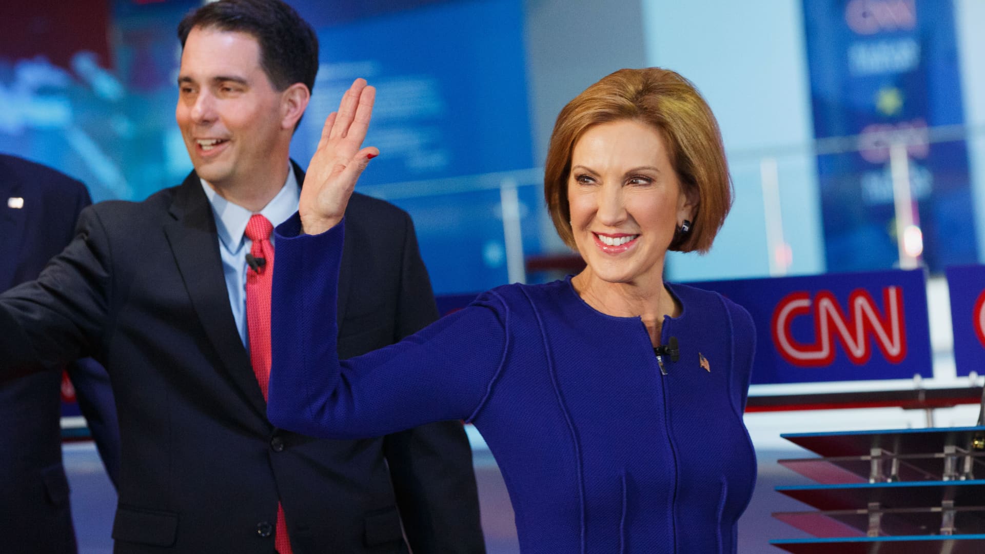 Republican presidential candidates Carly Fiorina, former chairman and chief executive officer of Hewlett-Packard Co., and Scott Walker, governor of Wisconsin, walk on stage during the Republican presidential debate at the Ronald Reagan Presidential Library in Simi Valley, California, Sept. 16, 2015.