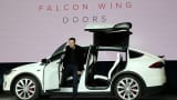 Tesla CEO Elon Musk demonstrates the falcon wing doors on the new Tesla Model X Crossover SUV during a launch event on Sept. 29, 2015, in Fremont, California.