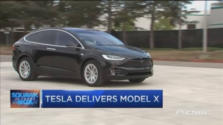 Tesla rolls out Model X with falcon wing doors