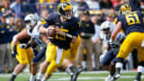 Quarterback Jake Rudock of the Michigan Wolverines rolls out and looks for a receiver against the Brigham Young Cougars at Michigan Stadium on September 26, 2015 in Ann Arbor, Michigan.