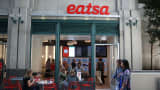 People walk by eatsa, a fully automated fast food restaurant on August 31, 2015 in San Francisco, California. eatsa, an automated fast food restaurant that has no servers, wait staff and a virtual cashier that offers fresh quinoa bowls opened in San Francisco's Financial District.