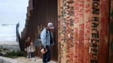 A man walks along the U.S.-Mexico border wall on February 22, 2015 in Tijuana, Mexico. Senior Republican senators said they expected Congress will avoid a shutdown over the Department of Homeland Security, which faces a partial shutdown on February 27 over a GOP push to roll back President Barack Obama's executive actions on immigration.