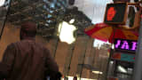 A pedestrian walks by an Apple store in New York.