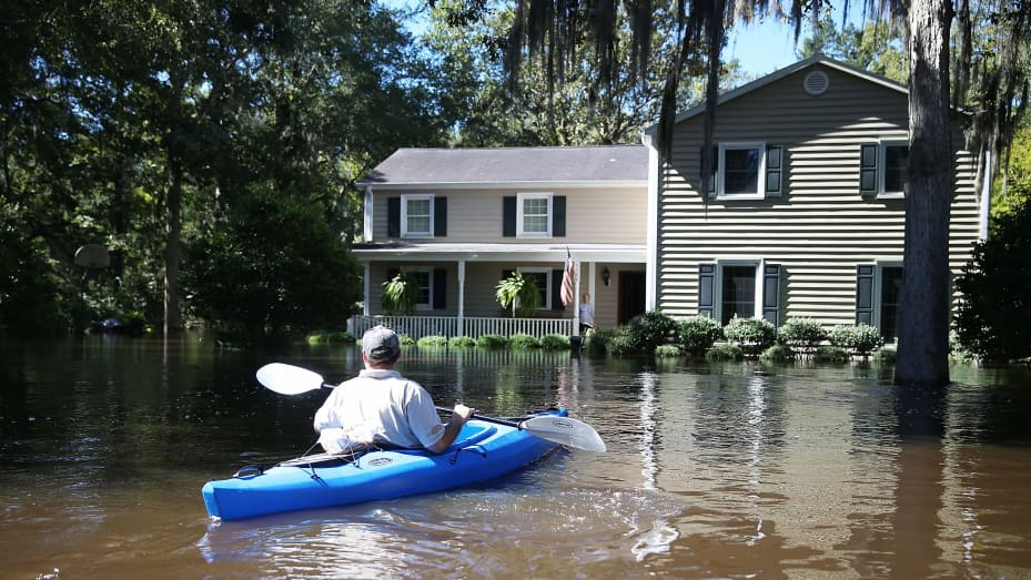 Chad Shields uses a kayak to deliver food to his parents after their home was flooded on October 7, 2015 in Summerville, South Carolina. The state of South Carolina experienced record rainfall amounts over the weekend and officials expect the damage from the flood waters to be in the billions of dollars.