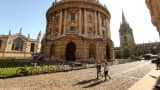 Students walk past the Radcliffe Camera building in Oxford city centre as Oxford University commences its academic year on October 8, 2009 in Oxford, England.