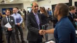 A job seeker (left) shakes hands with a recruiter during a WorkSource Seattle-King County Aerospace, Maritime and Manufacturing job fair in Seattle on Oct. 6, 2015.