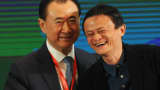 Wang Jianlin (L), chairman of the Dalian Wanda Group, shakes hands with Jack Ma, executive chairman of Alibaba Group last April.