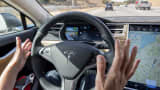 A member of the media test drives a Tesla Motors' Model S car equipped with Autopilot in Palo Alto, California.