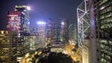 Commercial buildings stand illuminated in the Central business district of Hong Kong, China.