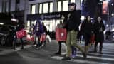Customers walks outside Macy's Herald Square after the store opened its doors at 8 pm Thanksgiving day in New York City.