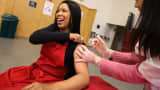 A woman receives a free flu shot from a Walgreens employee during a free flu shot clinic in Oakland, California.