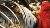 A worker polishes steel coils at a factory of Dongbei Special Steel Group in Dalian, China.