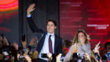 Justin Trudeau, Canada's prime minister-elect and leader of the Liberal Party of Canada, and his wife Sophie Gregoire-Trudeau wave to supporters on election night.