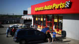 Customer vehicles sit parked outside an Advance Auto Parts automotive supply store in La Grange, Kentucky.