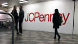 Pedestrians pass by a J.C. Penney sign in New York.