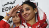 Deaf-mute Indian woman Geeta salutes the media before leaving for the airport from the EDHI Foundation in Karachi on October 26, 2015. Geeta, the Indian woman living in Pakistan after accidentally crossing the border over a decade ago, will return home with both governments completing all formalities.