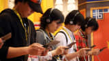 Attendees play video games on a Nintendo device in Chiba, Japan.