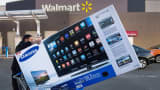 A Black Friday shopper pushes his TV after purchasing it at a Walmart in Fairfax, Virginia.