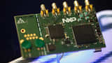 Microprocessors sit on a circuit board displayed on the NXP Semiconductors NV pavilion at the Mobile World Congress in Barcelona, Spain, on Monday, March 2, 2015.