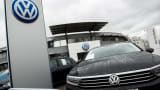 A Volkswagen AG badge sits on a Volkswagen Passat Estate automobile displayed on the forecourt of a dealership in Vienna, Austria, on Thursday, Oct. 8, 2015.