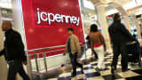 Shoppers pass a J.C. Penney store in New York.