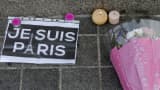 Candles, flowers and a leaflet with the slogan "I am Paris" are left in tribute to victims of Paris attacks in central Strasbourg, France, November 14, 2015.