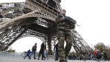 French military patrol near the Eiffel Tower the day after a series of deadly attacks in Paris , November 14, 2015.